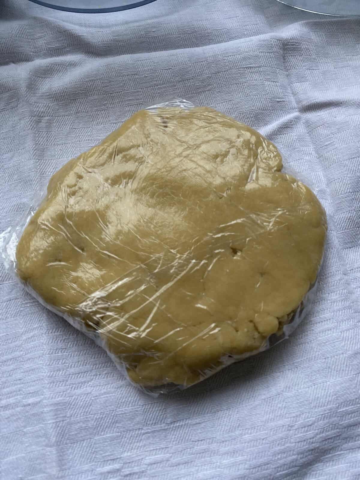 Pastry dough wrapped in cling film.