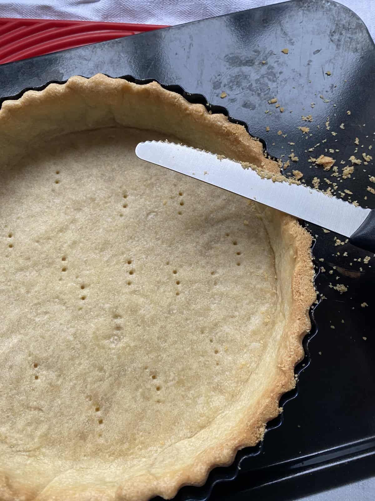 Neaten the pastry edges with a knife.
