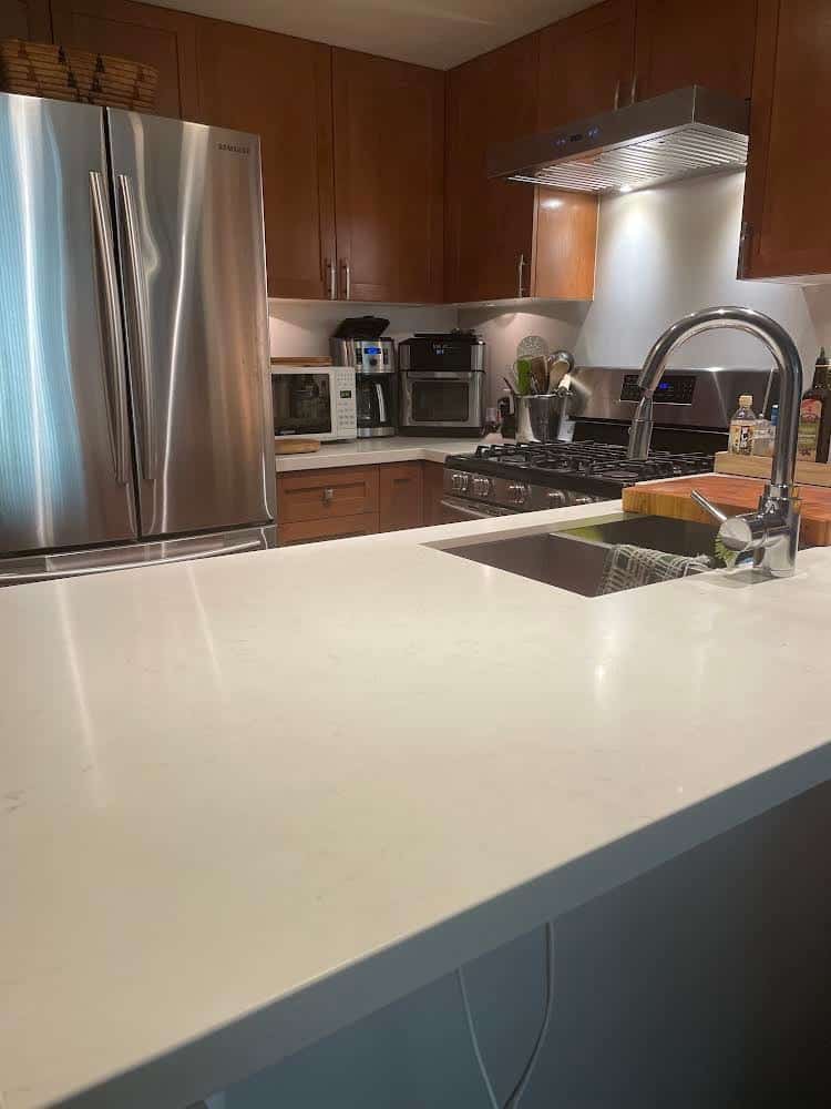 Kitchen with large fridge and counter top space.
