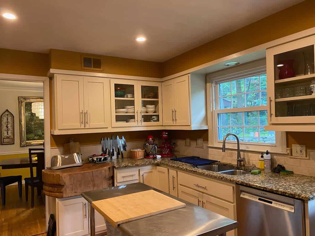 Kitchen with light coloured cupboard and butcher's block.