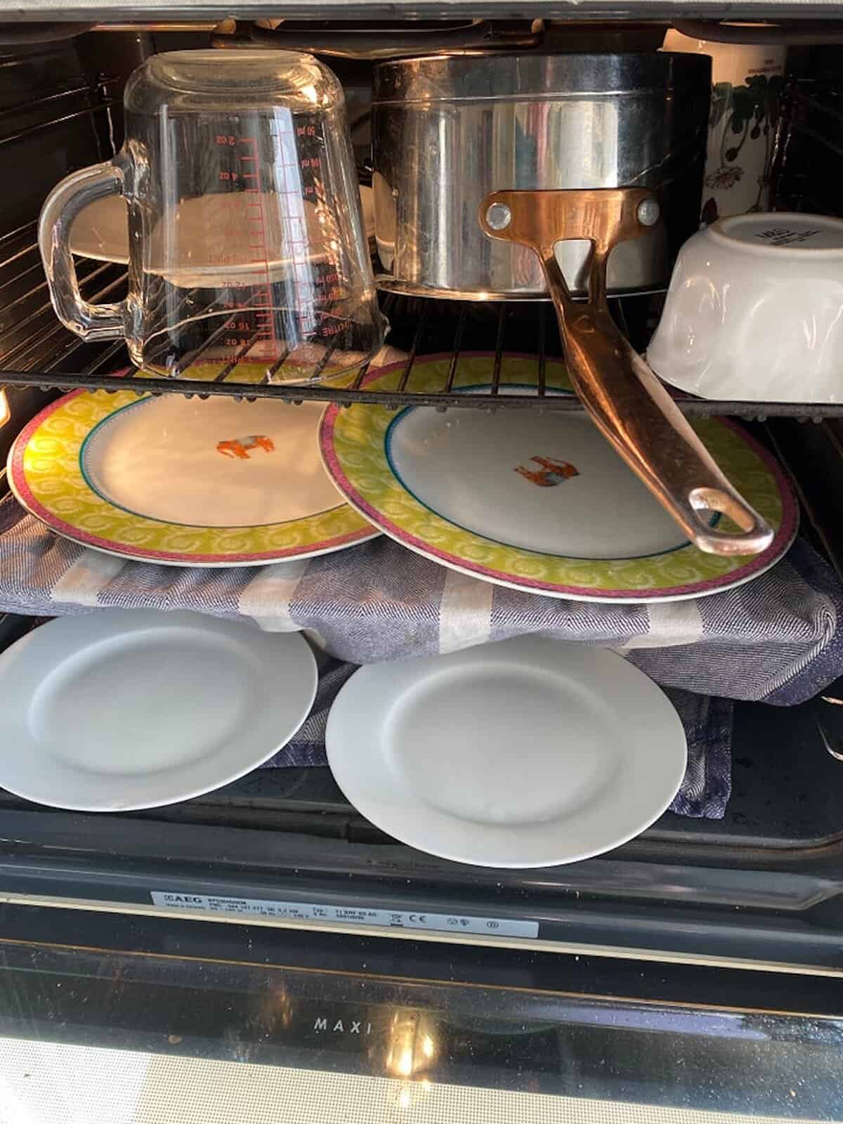 Drying pots and pans in the oven.