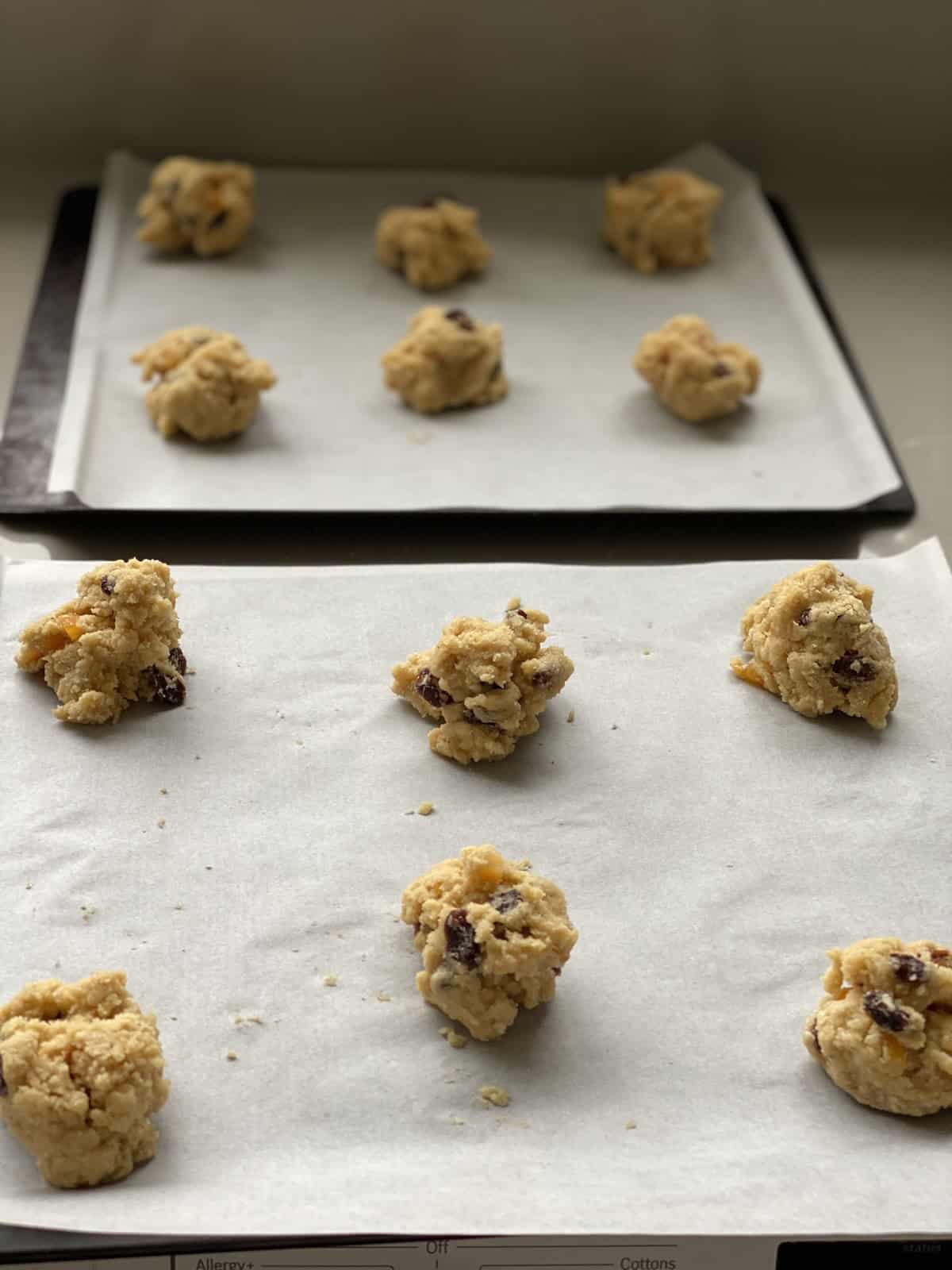 Mounds of unbaked Rcok Cakes on a baking tray.